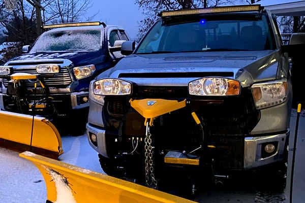 MVP work trucks fitted with plows for winter property services